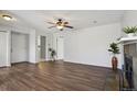 Spacious living room featuring lots of light and hardwood floors with fireplace at 3051 S Ursula Cir # 302, Aurora, CO 80014