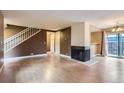Bright living room with wood floors, fireplace, and staircase; ideal for Gathering time and gatherings at 8759 E Roundtree Ave, Greenwood Village, CO 80111