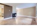 Spacious living room featuring a fireplace, wood floors, with great natural light from windows at 8759 E Roundtree Ave, Greenwood Village, CO 80111