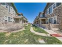 View of a row of townhomes, showcasing well-maintained landscaping and uniform architectural design at 552 S Mobile Pl, Aurora, CO 80017