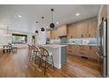 Modern kitchen featuring quartz countertops, stainless steel appliances, and a spacious island at 1423 Xavier St, Denver, CO 80204