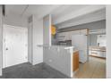 Open floor plan featuring a kitchen and entry hall area with neutral tones and ample natural light at 1888 S Jackson St # 604, Denver, CO 80210