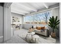 Cozy living room featuring a large window, modern decor, comfortable seating, and stylish shelving at 1888 S Jackson St # 604, Denver, CO 80210