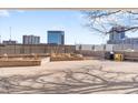Outdoor patio area with landscaping, a stone bench, and views of the surrounding city at 1888 S Jackson St # 604, Denver, CO 80210