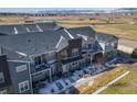 Stunning aerial view of the townhouses, highlighting the community, green spaces, and mountain backdrop at 821 Robert St, Longmont, CO 80503