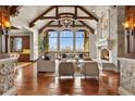 Bright living room featuring high ceilings, exposed beams, and a stone fireplace at 1880 Mallard Dr, Broomfield, CO 80020