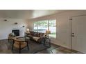 Inviting living room with a large window, cozy seating, and a fireplace, offering a relaxing space for Gathering and guests at 8800 W Kentucky Ave, Lakewood, CO 80226