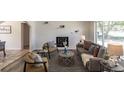 Bright living room features a comfortable sofa, armchairs, fireplace, and an open layout, creating an inviting atmosphere at 8800 W Kentucky Ave, Lakewood, CO 80226
