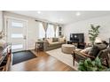 Cozy living room with hardwood floors, comfortable seating, and large windows for natural light at 1045 W 101St Ave, Northglenn, CO 80260