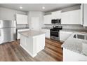 Bright kitchen with stainless steel appliances and white cabinets at 2244 Alyssa St, Fort Lupton, CO 80621