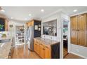 Open kitchen featuring wood cabinets, stainless steel appliances, granite counters, and views into the Gathering room at 2287 Pinto Trl, Elizabeth, CO 80107