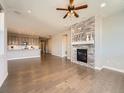 Inviting living room features hardwood floors, recessed lighting, and a striking fireplace with decorative mantle at 23709 E Caleb Pl, Aurora, CO 80016