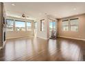 Bright living room featuring hardwood floors, fireplace, recessed lighting, and large windows with neighborhood views at 23709 E Caleb Pl, Aurora, CO 80016