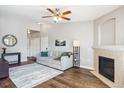 Cozy living room featuring a fireplace, ceiling fan, and neutral decor at 18669 Stroh Rd # 10208, Parker, CO 80134