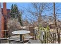 Outdoor balcony with a table and chairs, perfect for relaxing and enjoying the views at 2960 Ash St, Denver, CO 80207