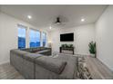 Spacious living room with sectional sofa, large windows, and ceiling fan at 1161 E Witherspoon Dr, Elizabeth, CO 80107