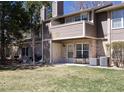 Backyard features a lawn, patio, two entrances and partial brick exterior with trees and sunshine at 2716 E Otero Pl # 6, Centennial, CO 80122