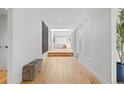 Bright hallway with hardwood floors leads to a living space with large windows and a skylight at 49 Charlou Cir, Cherry Hills Village, CO 80111