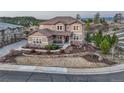 Charming two-story home with a well-manicured lawn and stone retaining wall at 5478 Water Oak Cir, Castle Rock, CO 80108