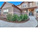 Inviting front entrance with a well-maintained landscape and walkway at 5478 Water Oak Cir, Castle Rock, CO 80108