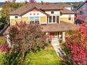 Luxury home with tree-lined street and neighborhood view at 9217 E 4Th Pl, Denver, CO 80230