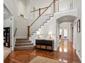 Bright and spacious entryway with hardwood floors and staircase at 9217 E 4Th Pl, Denver, CO 80230