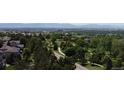 Aerial view of the neighborhood, with the verdant golf course and distant mountains visible on the horizon at 10619 N Osceola Dr, Westminster, CO 80031