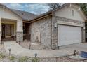 Inviting front exterior features a stone facade, walkway, and landscaped details that enhance the home's curb appeal at 10619 N Osceola Dr, Westminster, CO 80031