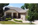 Charming home exterior featuring stone accents, a covered porch, a well-maintained lawn, and a peaceful water feature at 10619 N Osceola Dr, Westminster, CO 80031
