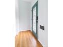 Clean entryway with wood floors and a decorative glass door, with a fresh coat of bright paint at 3613 Julian St, Denver, CO 80211