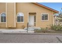 Welcoming home entrance with white door, sidelight windows and concrete steps for easy access at 10507 W Maplewood Dr # E, Littleton, CO 80127