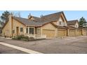 Charming townhouse exterior with manicured landscaping, inviting curb appeal and attached garages at 10507 W Maplewood Dr # E, Littleton, CO 80127