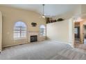 Bright living room with high ceilings, fireplace, arched windows and plush neutral carpet at 10507 W Maplewood Dr # E, Littleton, CO 80127