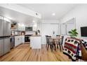 Bright dining area featuring modern table with seating, wood floors, and a stylish accent at 12478 W Nevada Pl # 208, Lakewood, CO 80228
