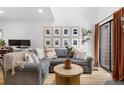 Comfortable living room featuring a gray sectional sofa, wood floors, and bright, natural light at 12478 W Nevada Pl # 208, Lakewood, CO 80228