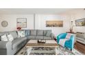 Comfortable living room with grey sectional, modern décor, and a cozy atmosphere at 7801 W 35Th Ave # 301, Wheat Ridge, CO 80033