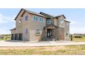 Stunning exterior elevation featuring a stone-accented entrance and three-car garage at 19887 Kershaw Ct, Monument, CO 80132
