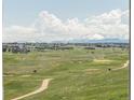 Enjoy this beautiful golf course view with mountain backdrops and big fluffy clouds at 19887 Kershaw Ct, Monument, CO 80132