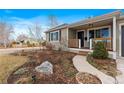 Landscaped front yard with walkway leading to porch at 2602 S Lafayette St, Denver, CO 80210