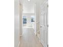 Light and spacious hallway with wood-look flooring at 8869 Sedalia St, Commerce City, CO 80022