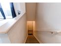 Interior staircase leading to a bright entryway with coat closet and natural light at 908 S Yampa St # 208, Aurora, CO 80017
