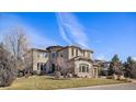 Beautiful two-story home featuring a lush front lawn, stone accents, and an inviting entrance at 12532 Daniels Gate Dr, Castle Pines, CO 80108