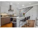 Open concept kitchen showcasing an island with bar seating, stainless appliances, and modern cabinetry at 1216 Perry St, Denver, CO 80204