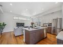 Open kitchen featuring a center island, stainless appliances, and seamless flow into the living area at 1216 Perry St, Denver, CO 80204