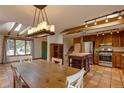 Open concept kitchen features wood cabinets, stainless steel appliances, skylights, and a large dining area for Gathering gatherings at 3722 Monterey Pl, Boulder, CO 80301