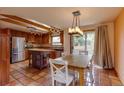 Modern kitchen and dining area boast stainless steel appliances, wood cabinets, skylights, and sliding glass doors to the backyard at 3722 Monterey Pl, Boulder, CO 80301