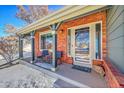 Inviting front porch with brick accents and seating area at 4702 S Biscay Ct, Aurora, CO 80015