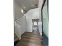 Inviting entryway with soaring ceilings, modern flooring, and a view of the staircase at 2142 S Irvington St, Aurora, CO 80018