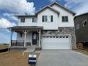 Charming two-story home with stone accents, a covered porch, and a two-car garage at 2142 S Irvington St, Aurora, CO 80018