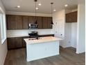 Modern kitchen featuring an island, stainless steel appliances, and stylish pendant lighting at 2142 S Irvington St, Aurora, CO 80018